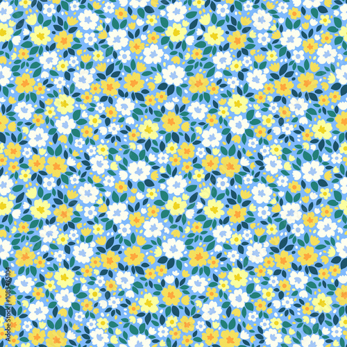 Beautiful floral pattern in small flowers. Small white and yellow flowers. Light blue background. Ditsy print. Floral seamless background. Gentle template for fashion prints. Stock pattern.