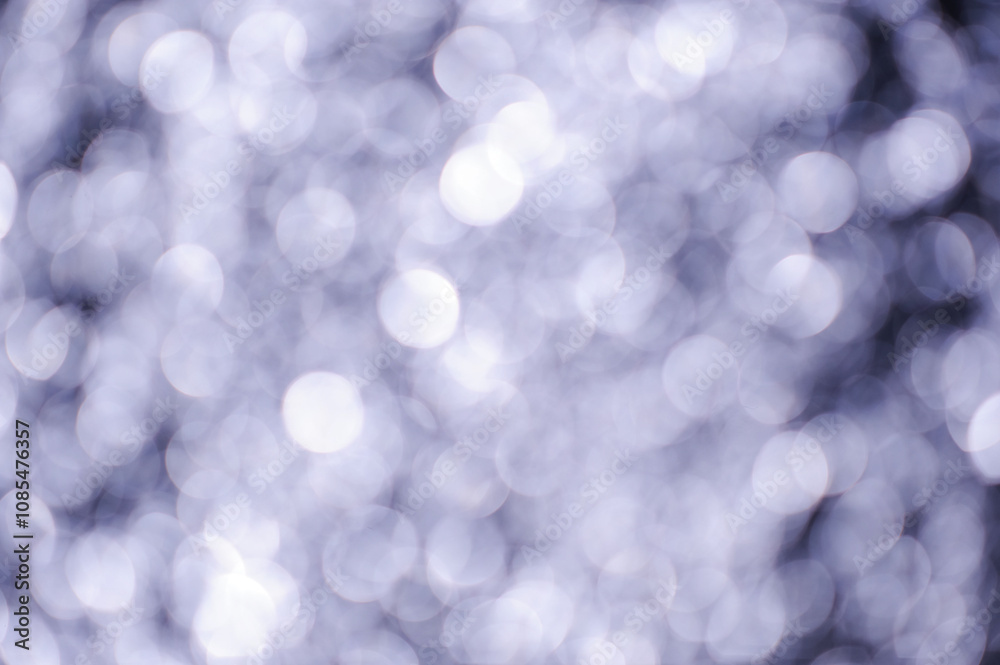 Blurred, out-of-focus circles of light shimmer and blend, suggesting water reflecting the ambient light of sunset Blurred, out-of-focus circles of light shimmer and blend, suggesting water reflecting the ambient light of sunset