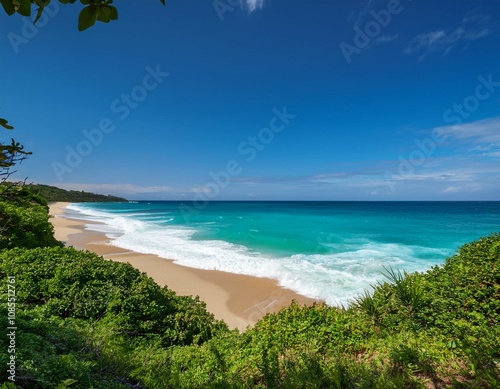 turquoise ocean waves crash on the sandy beach framed by lush greenery under a clear sky during daylight creating a serene coastal atmosphere