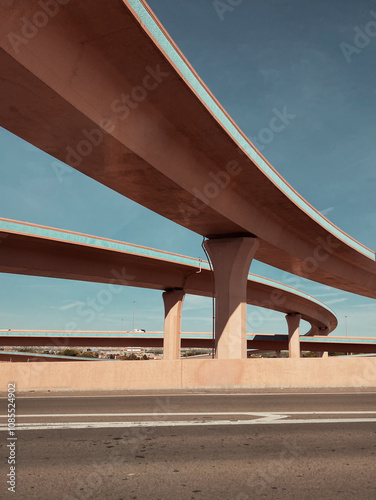 Highway overpasses in Albuquerque, New Mexico, showcasing sweeping concrete structures under a clear blue sky. A modern architectural perspective of urban infrastructure in the American Southwest