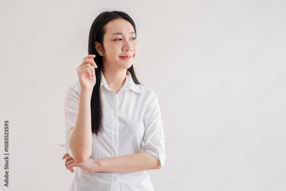 Confident Young Woman in White Shirt Holding Pen and Thinking Against Plain Background Confident Young Woman in White Shirt Holding Pen and Thinking Against Plain Background