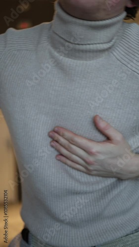 Wallpaper Mural The individual in the image seems to be in discomfort, holding their hand to their chest. Their forward-leaning posture and reaching for support suggest a possible issue related to their heart or ches Torontodigital.ca