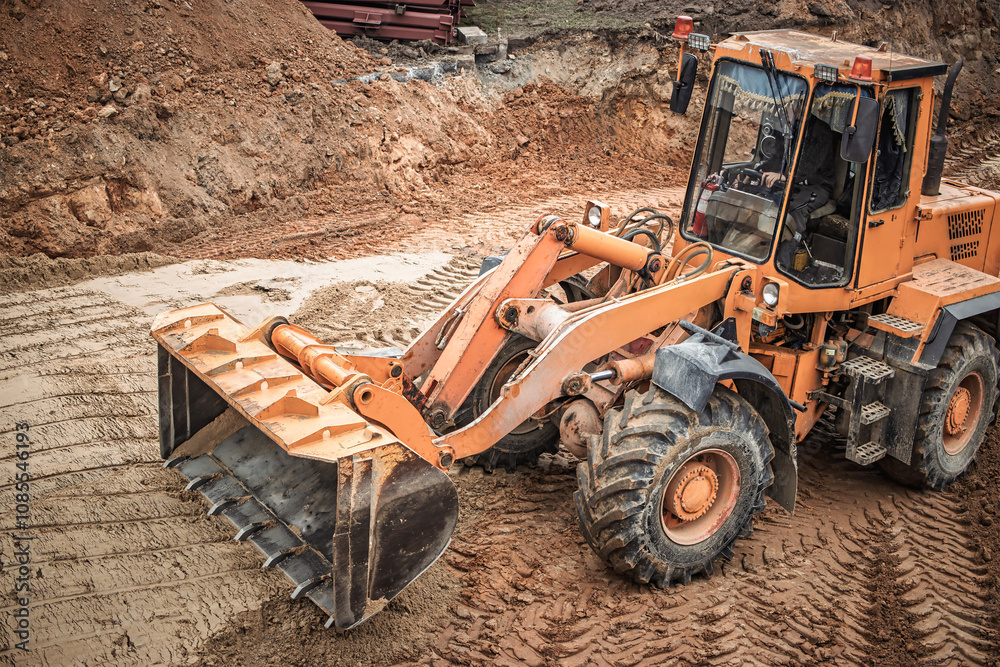 Heavy machinery working on a construction site during daylight hours, moving earth and material to create a solid foundation for new structures Heavy machinery working on a construction site during daylight hours, moving earth and material to create a solid foundation for new structures