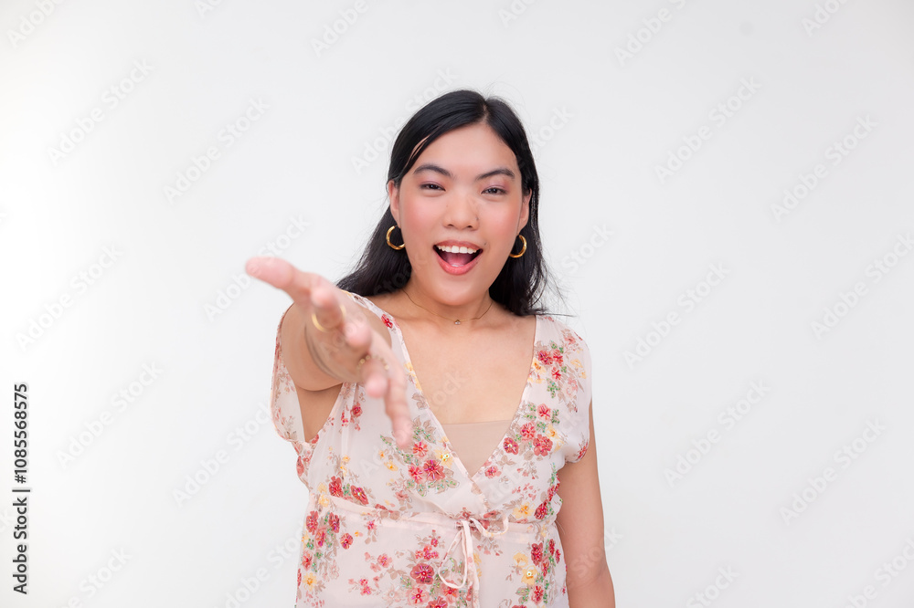 Smiling woman in floral blouse reaching out her hand invitingly Smiling woman in floral blouse reaching out her hand invitingly