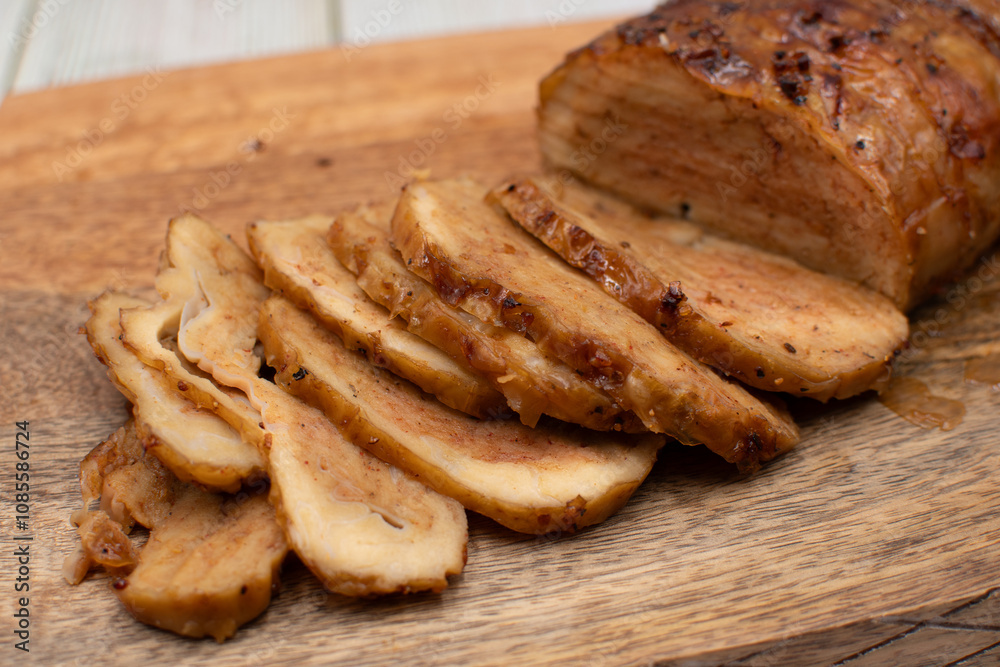 Seitan: vegan meat alternative made of washed flour gluten spices. Roasted and served on wooden board Seitan: vegan meat alternative made of washed flour gluten spices. Roasted and served on wooden board