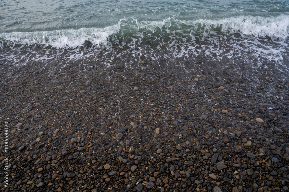 Water sea beach. Wave ocean blue. Stone texture reflection sun. Surface coast pebbles. Water sea beach. Wave ocean blue. Stone texture reflection sun. Surface coast pebbles.