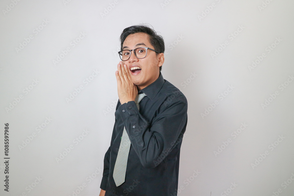 Asian man wearing black shirt is whispering expression Asian man wearing black shirt is whispering expression