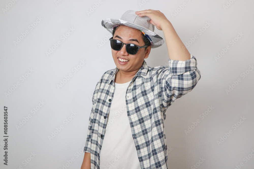 Excited young Traveler tourist Asian man in casual clothes hat holds city map during the excursion, looking aside on yellow background. Passenger traveling on weekend. Air flight journey concept Excited young Traveler tourist Asian man in casual clothes hat holds city map during the excursion, looking aside on yellow background. Passenger traveling on weekend. Air flight journey concept