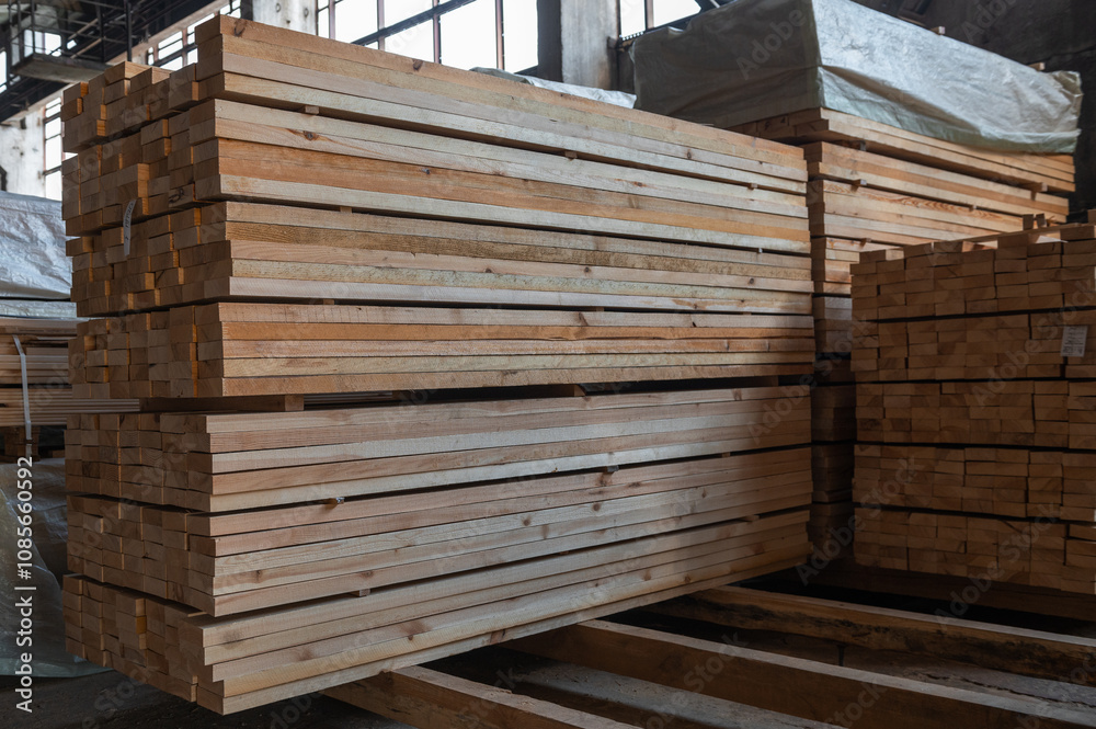 Stacked wooden planks close-up at lumber warehouse. Wood industry concept Stacked wooden planks close-up at lumber warehouse. Wood industry concept