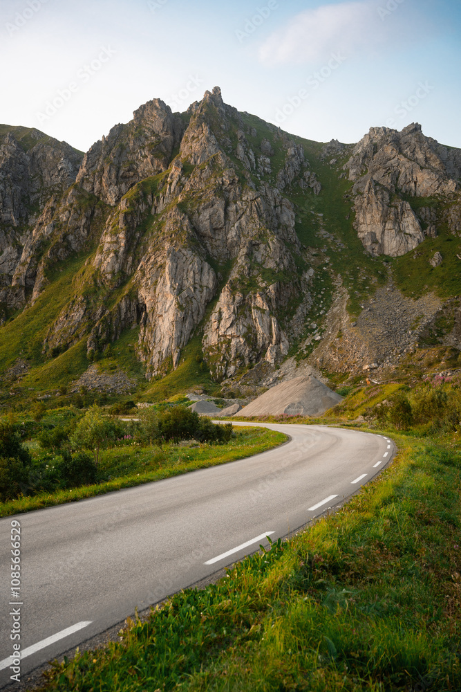 Winding road that meanders gracefully through a serene, breathtaking mountain landscape Winding road that meanders gracefully through a serene, breathtaking mountain landscape