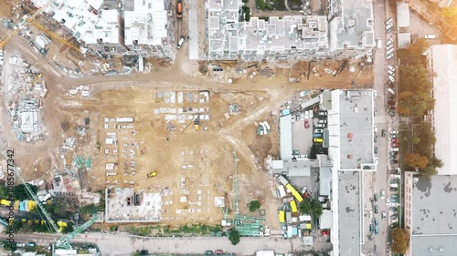 Construction progress in urban area showing residential building sites and infrastructure development in a city setting