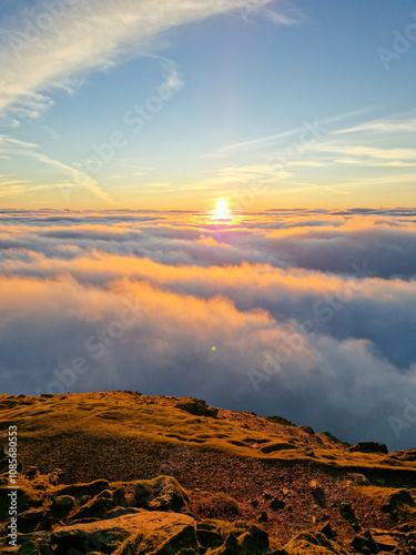 Breathtaking Sunrise Above the Clouds on Snowdon Summit, Snowdonia National Park in Wales
