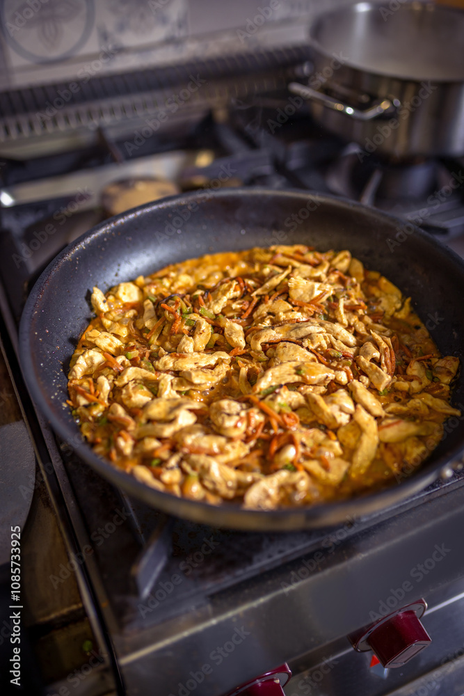 Chef frying cut vegetables and chicken in pan in restaurant kitchen. Chef frying cut vegetables and chicken in pan in restaurant kitchen.
