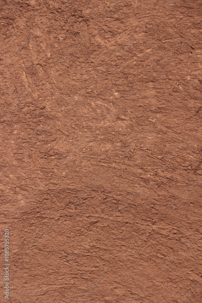 Vertical Brown texture of wall of rural Indian house made from clay mixed with cow dung. Vertical Brown texture of wall of rural Indian house made from clay mixed with cow dung.