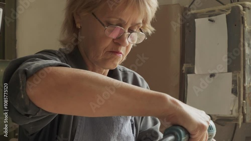 Cinematic Close Up View Of An Artisan Grinding Improvement. Skillful Woman With Glasses On Showing Artisan Grinding Improvement. Artisan Grinding Improvement In A Workshop Room. Carpentry