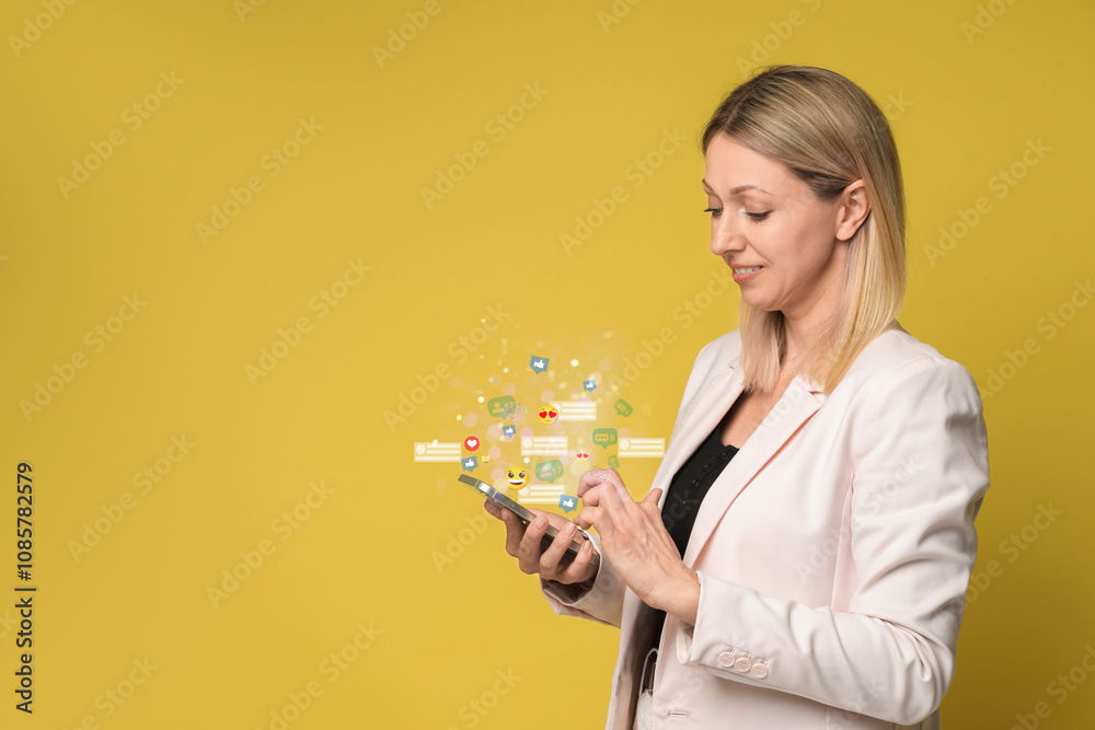 Happy woman using mobile phone on orange background. Different notification signs over gadget Happy woman using mobile phone on orange background. Different notification signs over gadget