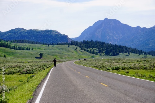 Man on a journey walks alone on a long and winding road