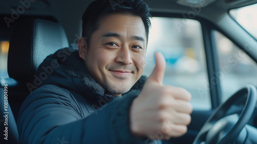 Smiling man giving thumbs up while sitting in van