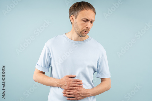 Unhealthy man with gastrointestinal problems with stomach pain, bloating, cramps, sharp aches. Discomfort abdominal health issues food poisoning, ulcers, irritable bowel syndrome, digestive disorders