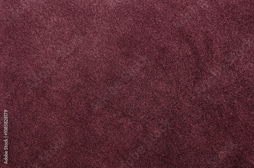 Close-up of rich burgundy velour texture, showcasing a smooth and soft fabric surface.