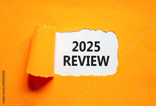 Planning 2025 review new year symbol. Concept words 2025 Review on beautiful white paper. Beautiful orange paper background. Business 2025 review new year concept. Copy space.