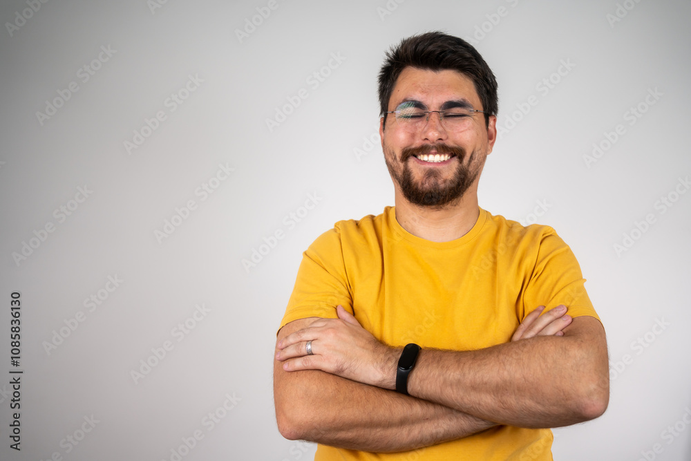Portrait of happy fashionable handsome man in yellow t-shirt and glasses crossing hands and smiling. Portrait of handsome smiling young man with folded arms. Isolated on gray background
Portrait of happy fashionable handsome man in yellow t-shirt and glasses crossing hands and smiling. Portrait of handsome smiling young man with folded arms. Isolated on gray background