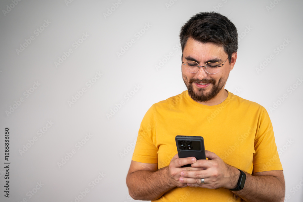 Successful young handsome businessman using phone. Medium shot of a joyful young man holding mobile phone. Always in touch. Happy man using mobile phone isolated over grey background. Successful young handsome businessman using phone. Medium shot of a joyful young man holding mobile phone. Always in touch. Happy man using mobile phone isolated over grey background.
