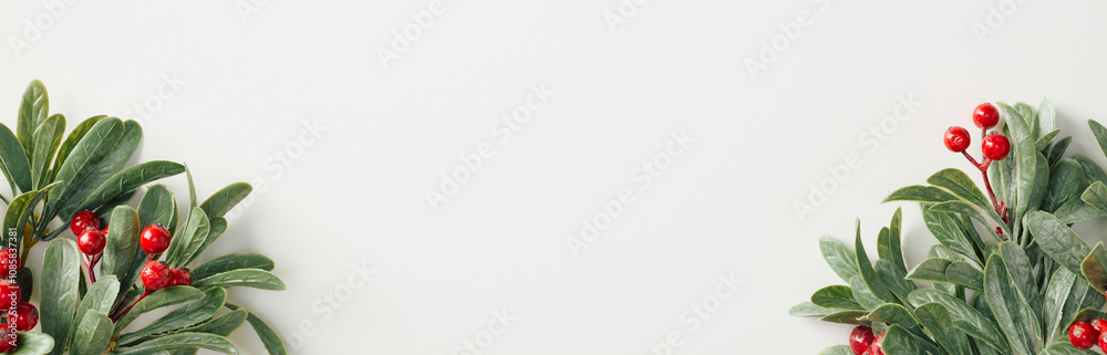 Xmas banner design with festive holly branches with red berries isolated on whte background. Christmas, winter, New Year holidays celebration concept Xmas banner design with festive holly branches with red berries isolated on whte background. Christmas, winter, New Year holidays celebration concept