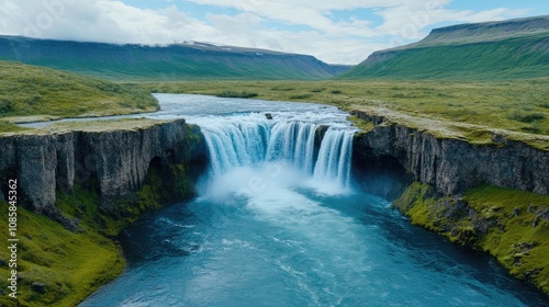 Discover the captivating beauty of Godafoss waterfall surrounded by lush greenery and clear blue water in Iceland's stunning landscape