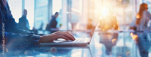 Businesswoman Working on Laptop in Modern Office with Blurred Background