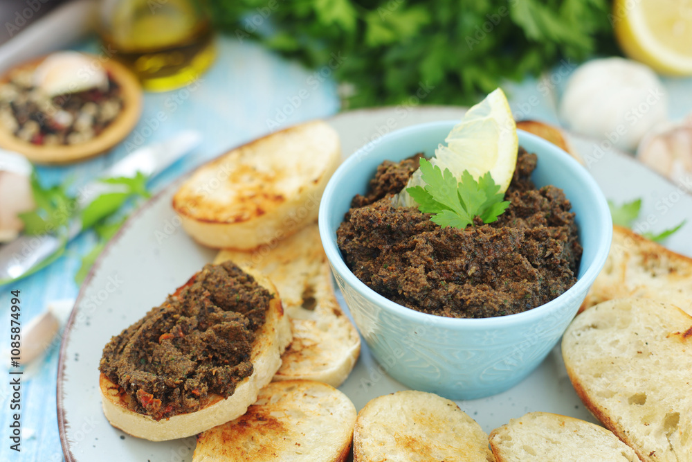 A bowl with tapenade - traditional olive dip in Mediterranean region A bowl with tapenade - traditional olive dip in Mediterranean region