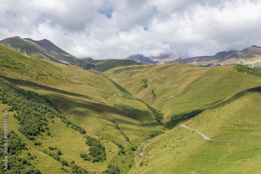 Caucasian mountains near Gergeti village, Stepansminda. Kazbegi mountain behind the clouds. Georgia