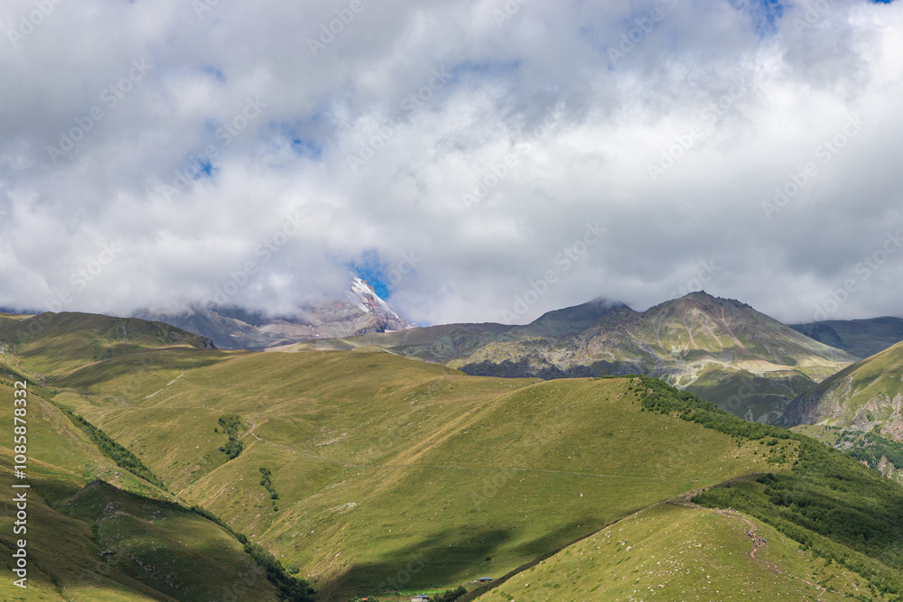 Caucasian mountains near Gergeti village, Stepansminda. Kazbegi mountain behind the clouds. Georgia