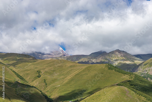 Obraz na płótnie Caucasian mountains near Gergeti village, Stepansminda. Kazbegi mountain behind the clouds. Georgia w salonie