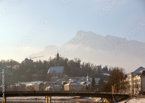 SALZBURG, AUSTRIA - 01.13.2024: View of Salzach mountain and Historic city of Salzburg with Salzach river in Austria in winter. photo