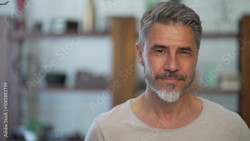 Schilderij op canvas Portrait of happy, confident older man at home looking at camera smiling