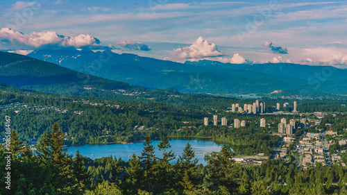 Aerial view of Fraser Valley, BC, with Burrard Inlet at Port Moody and forested mountain backdrop.