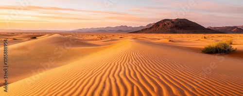 Serene desert landscape at sunset with dunes.