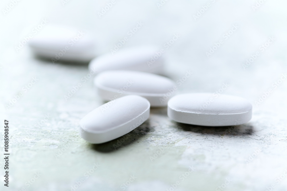 White tablets on wooden background. Soft focus. Close up. Copy space White tablets on wooden background. Soft focus. Close up. Copy space