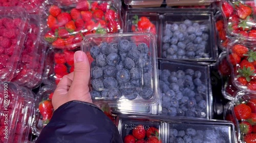 buying fruits and  berries ( raspberries, blueberries, strawberries, gooseberries)at the market