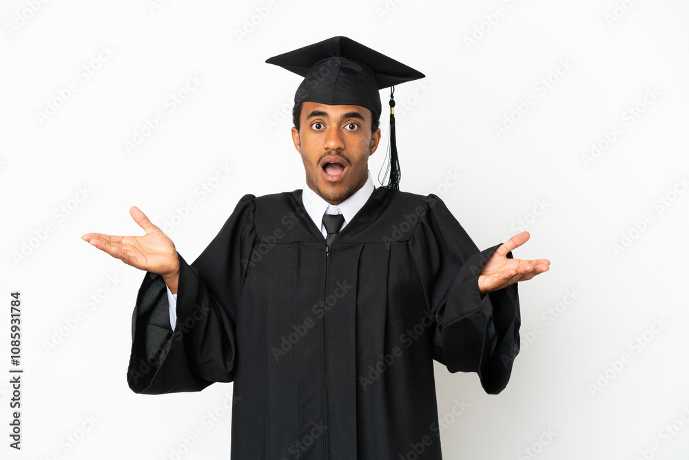 African American university graduate man over isolated white background with shocked facial expression African American university graduate man over isolated white background with shocked facial expression