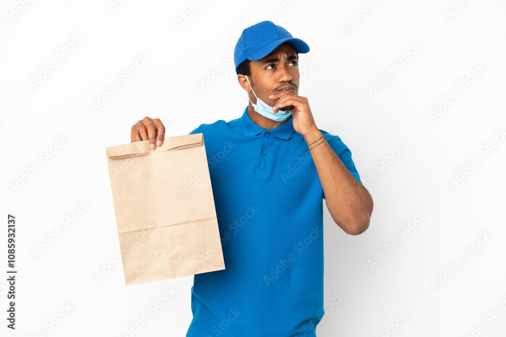 African American man taking a bag of takeaway food isolated on white background and looking up African American man taking a bag of takeaway food isolated on white background and looking up