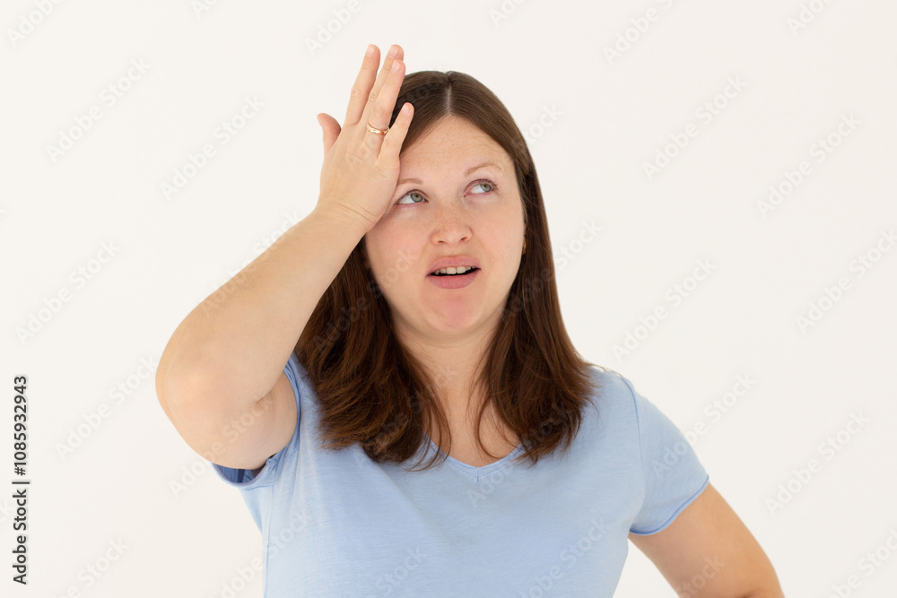 Portrait of unhappy displeased and annoyed young arrogant woman in blue top facepalming with irritation breathing out with opened mouth and rolling eyes from annoyance and exhaust Portrait of unhappy displeased and annoyed young arrogant woman in blue top facepalming with irritation breathing out with opened mouth and rolling eyes from annoyance and exhaust