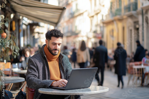 Remote worker sitting at a cafe in a bustling European city square, working on a laptop as people pass by.