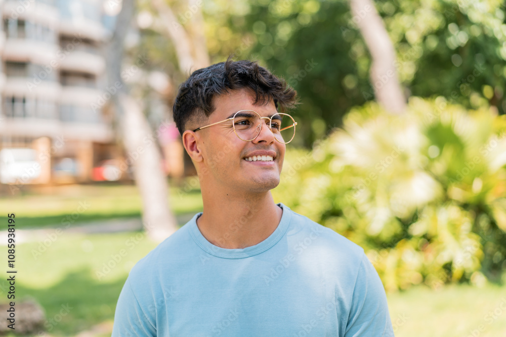 Young hispanic man at outdoors With glasses with happy expression Young hispanic man at outdoors With glasses with happy expression
