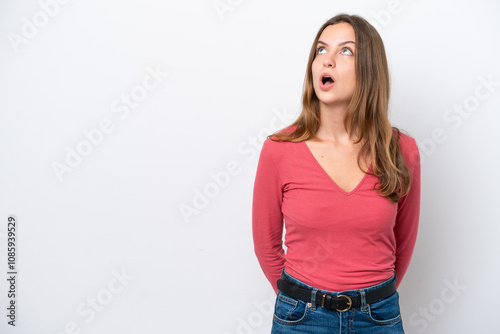 Young caucasian woman isolated on white background looking up and with surprised expression