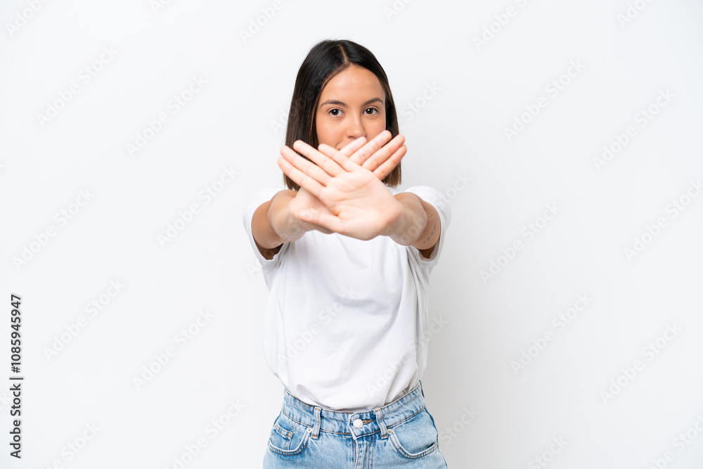 Young caucasian woman isolated on white background making stop gesture with her hand to stop an act Young caucasian woman isolated on white background making stop gesture with her hand to stop an act