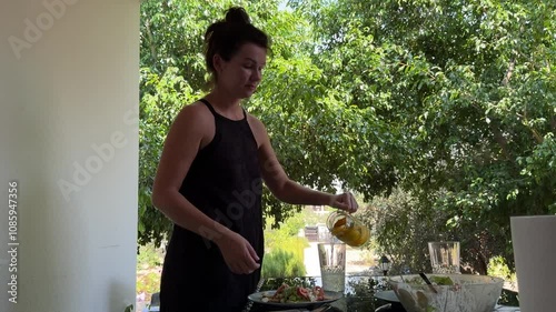 Woman pouring lemonade in glass 