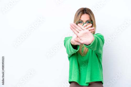 Young Uruguayan woman isolated on white background making stop gesture with her hand to stop an act