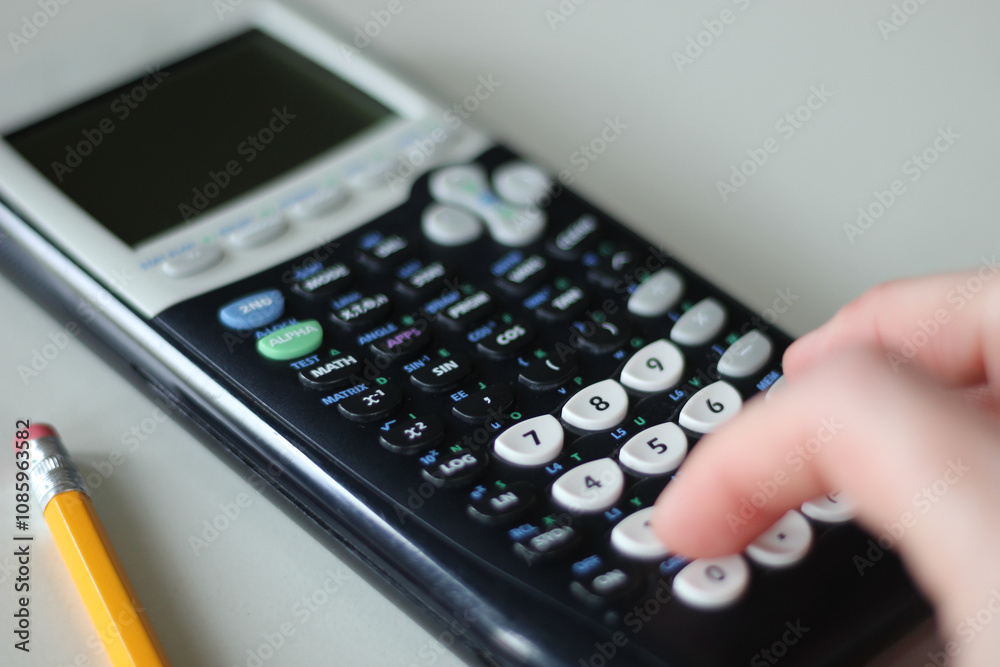 person using calculator with pencil on table isolated on white background person using calculator with pencil on table isolated on white background
